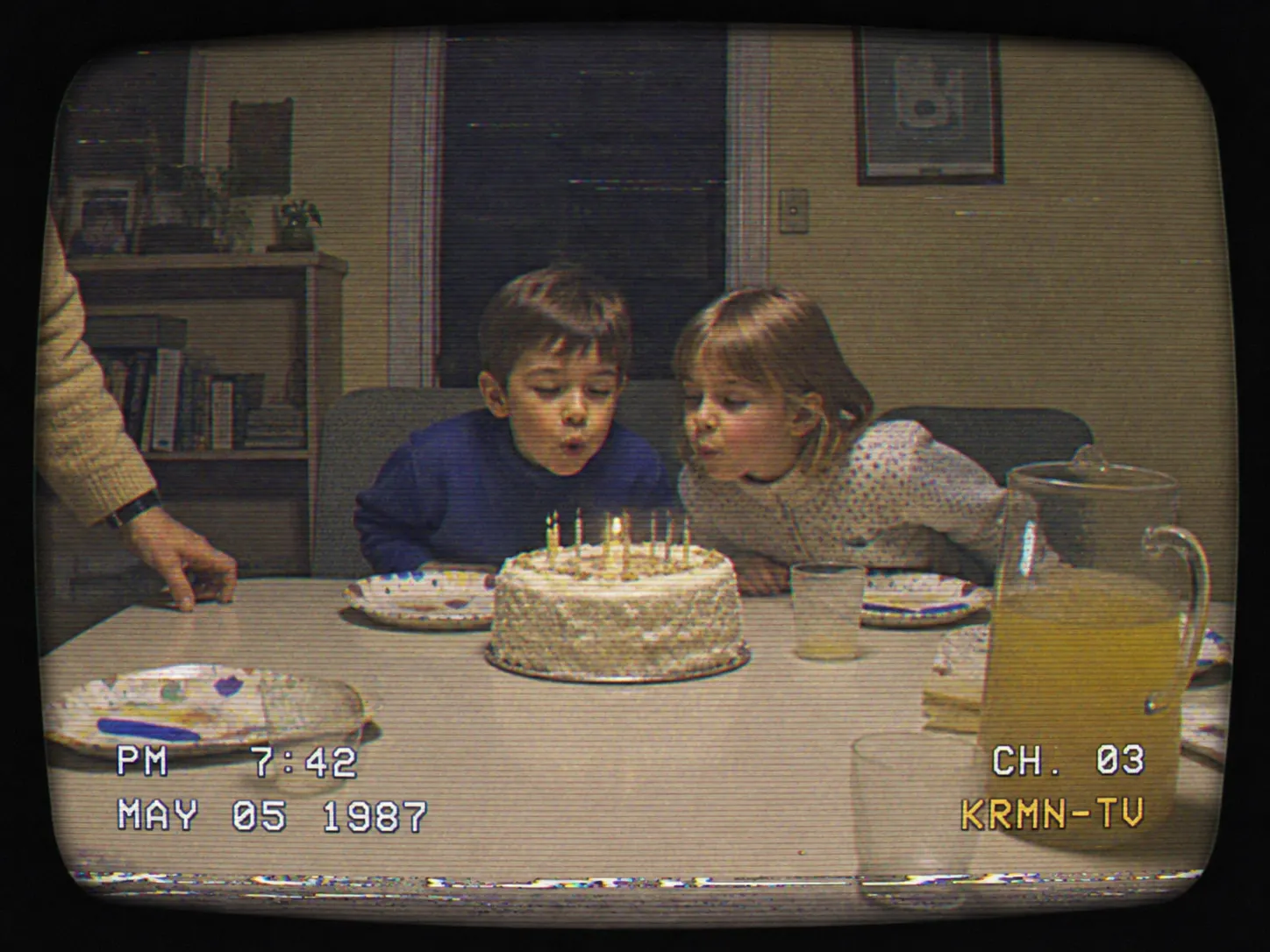 A family scene held in the same broadcast look, from the burned-in corner overlay to the softness of the picture.