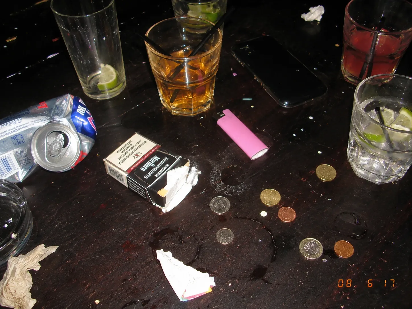 Table debris shot from above at close range, the surface bright and the floor beyond it gone.