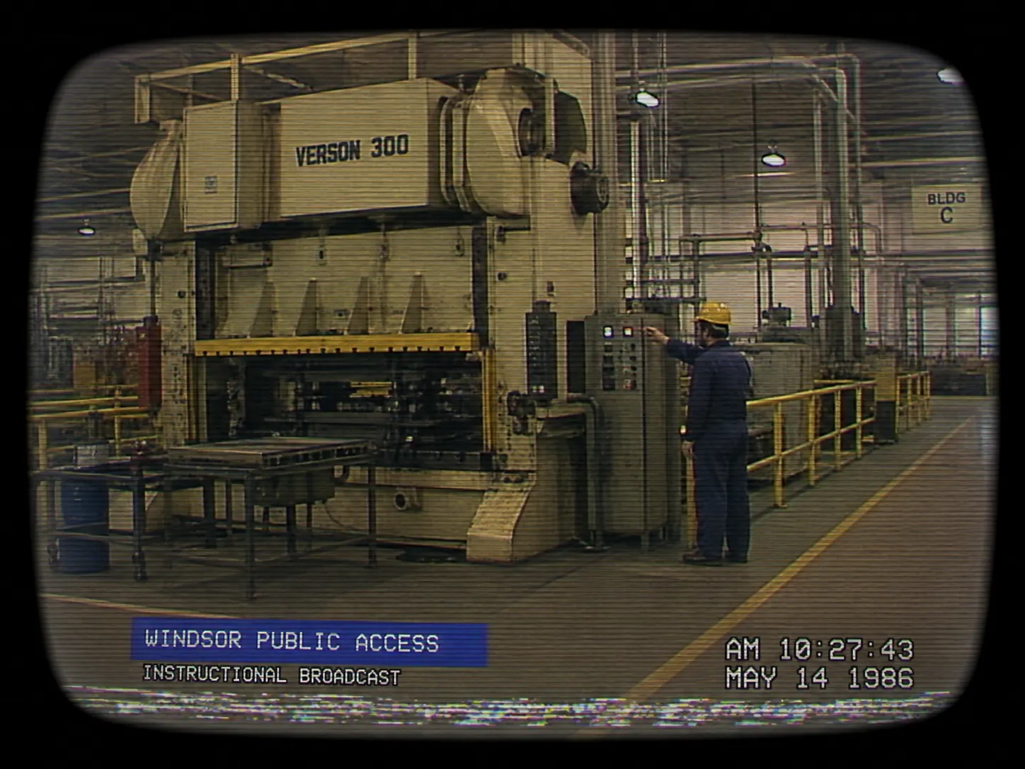 An industrial subject at wide scale, rendered with the same tracking damage, flat lighting and corner overlay.